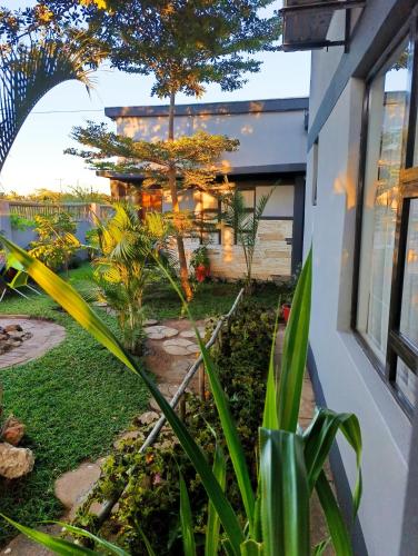 a garden in front of a house at Shalakwe Hills-Inn Guesthouse Kasane in Kasane