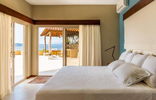 Postel nebo postele na pokoji v ubytování Villas Roma Del Mar