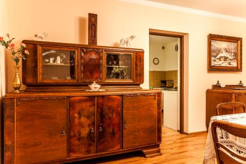 a large wooden cabinet in a living room at Willa Stróża in Myślenice