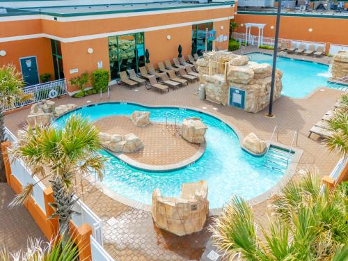 an overhead view of a swimming pool in a resort at Holiday Inn & Suites Virginia Beach - North Beach by IHG in Virginia Beach