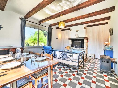 a living room with a table and a fireplace at Holiday Home La Sablière by Interhome in Saint-Georges-dʼOléron
