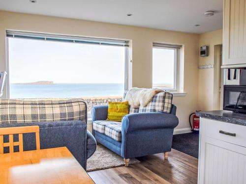 a living room with a view of the ocean at Apartment Solas Alainn Chalet by Interhome in Stenscholl