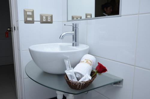 a bathroom with a sink on a glass table at Golden Inca Hotel in Cusco
