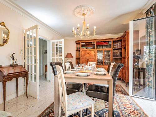 une salle à manger avec une table, des chaises et un lustre dans l'établissement Holiday Home Martin by Interhome, à Saint-Père