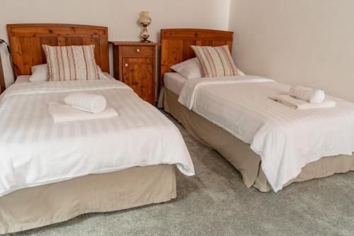 two beds with towels on them in a bedroom at Penzion Ztracený mlýn in Slapy