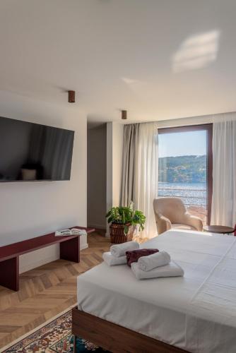 a hotel room with a bed with two towels on it at Villa Remi in Sumartin