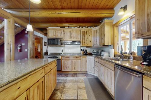 a large kitchen with wooden cabinets and granite counter tops at Forestside Lodge in Leavenworth