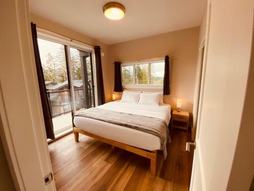 a bedroom with a bed and a window at Haven On The Hill in Port Renfrew