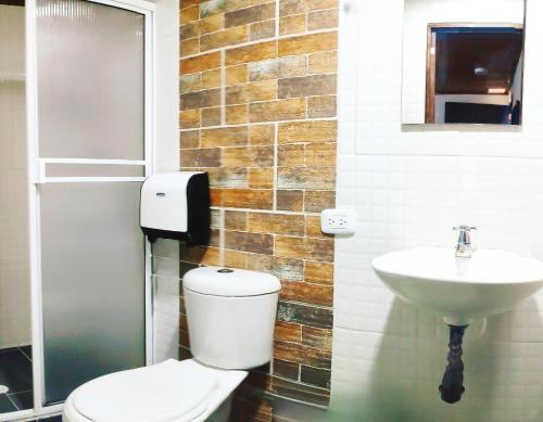 a bathroom with a toilet and a sink at SAN PEDRO SALENTO Apartahotel in Salento