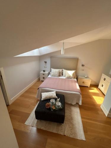 a large bedroom with a bed and a table at Bournacell 16 in Cambados