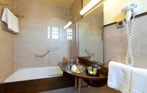 a bathroom with a sink and a tub and a shower at Victoria 4 Puerta del Sol in Madrid