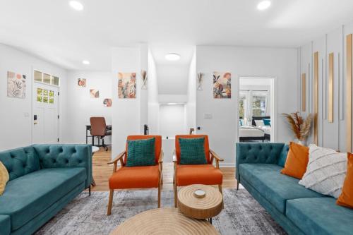 a living room with blue couches and orange chairs at NYC 20min Free Parking Hot Tub EWR 15min in Bayonne