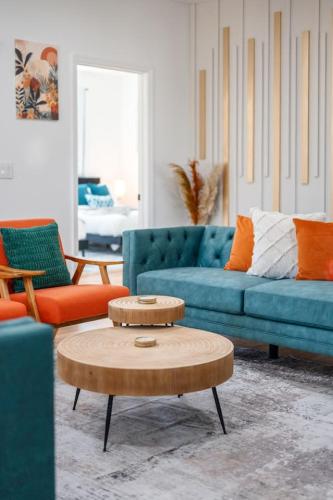 a living room with a blue couch and a coffee table at NYC 20min Free Parking Hot Tub EWR 15min in Bayonne