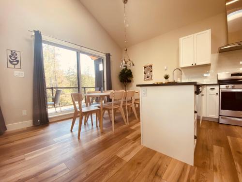 a kitchen and dining room with a table and chairs at Haven On The Hill in Port Renfrew