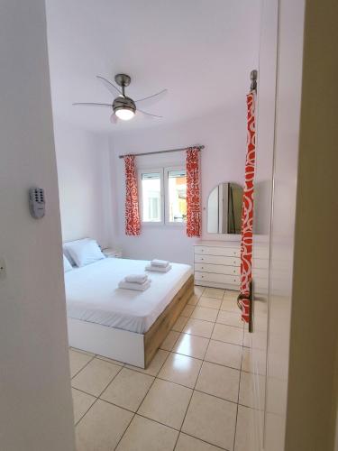 a small bedroom with a bed and a window at Siviri Blue Horizon Apartment in Siviri