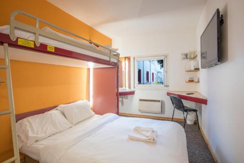 a bedroom with a bunk bed and a desk at Metro Inns Teesside in Stockton-on-Tees