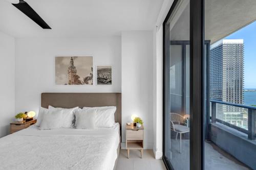 a bedroom with a white bed and a large window at Bright and Breezy 1 Bed Unit With Water and City Views in Miami