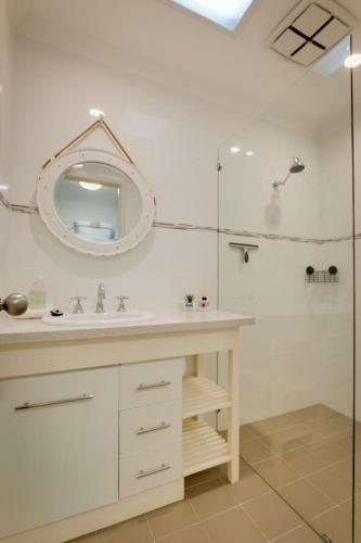 a white bathroom with a sink and a shower at Karla Kuliny - A Peaceful Escape in Quindalup