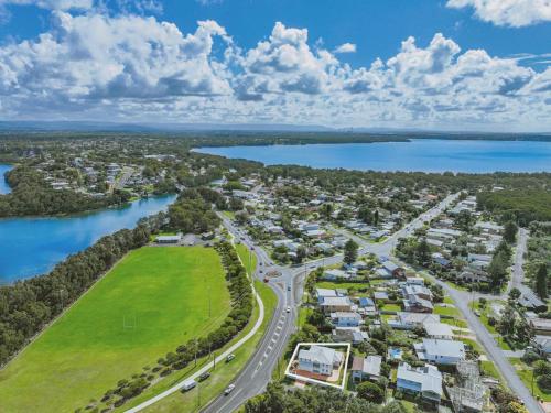 an aerial view of a town next to a river at Coastal Cove in Budgewoi