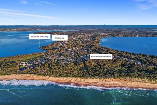 an aerial view of an island in the ocean at Coastal Cove in Budgewoi