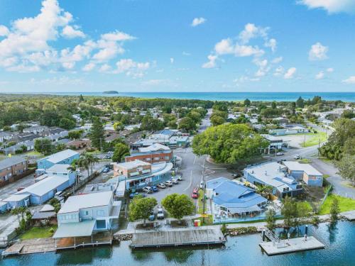 an aerial view of a small town next to the water at Coastal Cove in Budgewoi