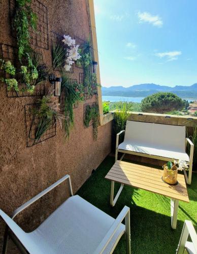 two chairs and a table on a balcony with a view at SOL Y LUNA 11 Apartment in Sardinia close to the beach and to Olbia airport in Olbia