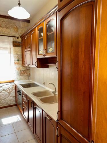 a kitchen with wooden cabinets and a sink at Kappa Domus in Siviri