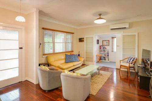 a living room with a couch and a table at Pebbles by the Bay - Central Busselton in Busselton