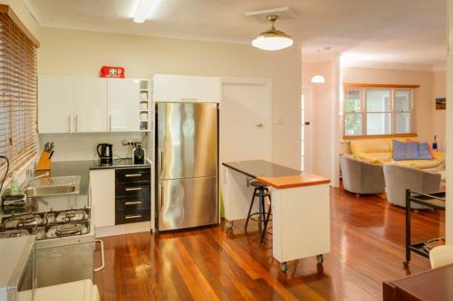 a kitchen with a stainless steel refrigerator in a room at Pebbles by the Bay - Central Busselton in Busselton