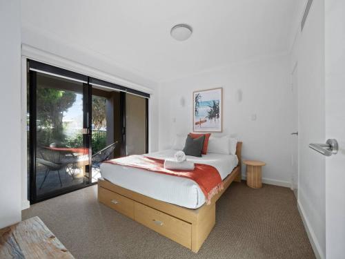 a bedroom with a bed and a large window at Seventh Heaven Surfside in Yallingup