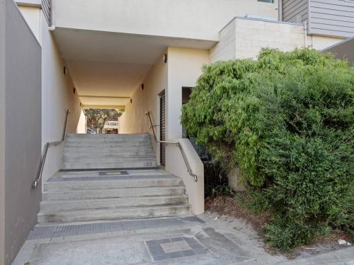 a staircase leading up to a building with a bush at Seventh Heaven Surfside in Yallingup