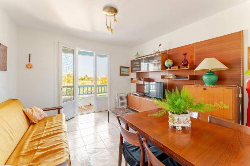 un salon avec une table et un canapé dans l'établissement Appartement traversant vue sur l'étang, à Saintes-Maries-de-la-Mer