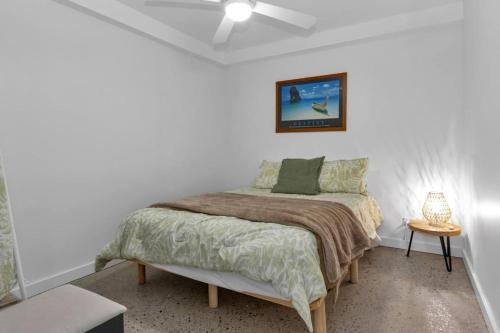 a bedroom with a bed in a white room at Beach house at Port Willunga in Port Willunga
