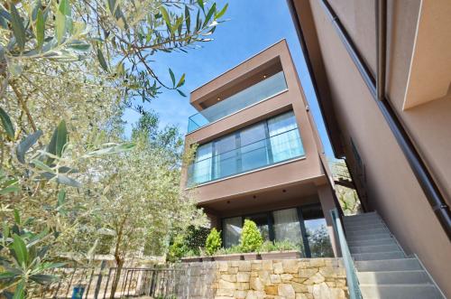 a house with glass windows and stairs in front at Royal Olive Residence in Kotor