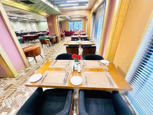 a long dining room with tables and chairs at The Zabeer Dhaka in Dhaka