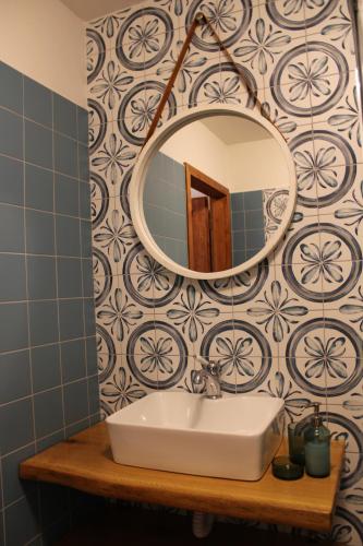 a bathroom with a sink and a mirror at Penzion Ztracený mlýn in Slapy