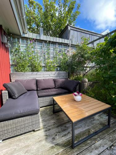 a couch and a coffee table on a patio at Stuga smögen in Smögen