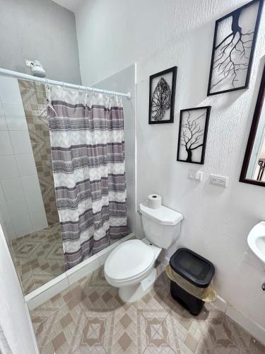 a bathroom with a toilet and a shower and a sink at Casa Mama Fanti in Esquipulas
