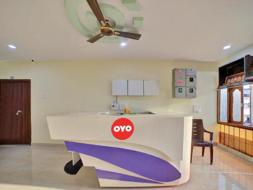 a desk in a room with a ceiling fan at SPOT ON SRI DATTA GRAND INN in Warangal