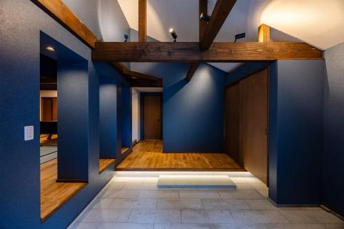 a hallway with blue walls and wooden beams at Auberge S'Amuser - Vacation STAY 96495v in Sakai