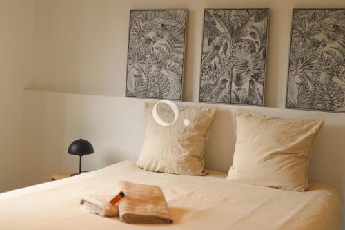 a bed with two pillows and a towel on it at COC - La Palme in Wissant
