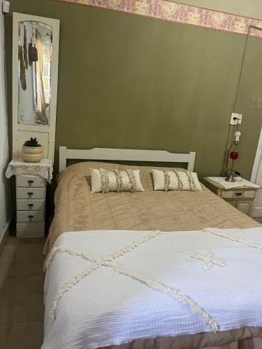 a bedroom with a bed and a green wall at La Casona de Emilia in Corrientes