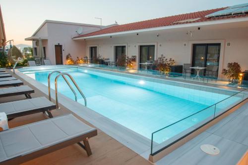 a large swimming pool with blue water at GAIA Suites in Fanárion
