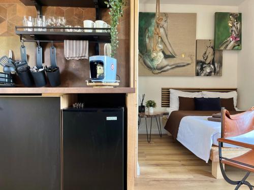 a bedroom with a bed and a room with a table at Garden Residence - The Nest in Drahobudice