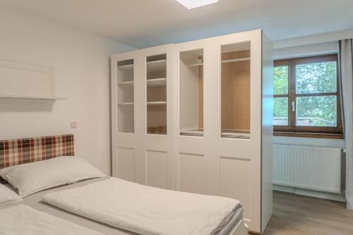 a bedroom with a white closet and a bed at 2 Bedroom Apartment with access to Attersee Lake in Seewalchen