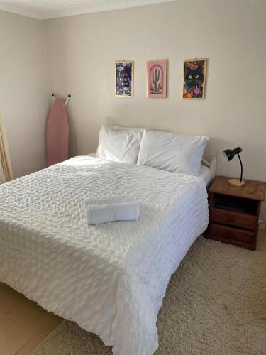 a white bed with a white tray on top of it at Zambarau house in Busia