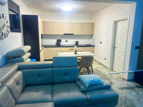 a living room with a couch and a kitchen at Villa Nova Bar in Zaljevo