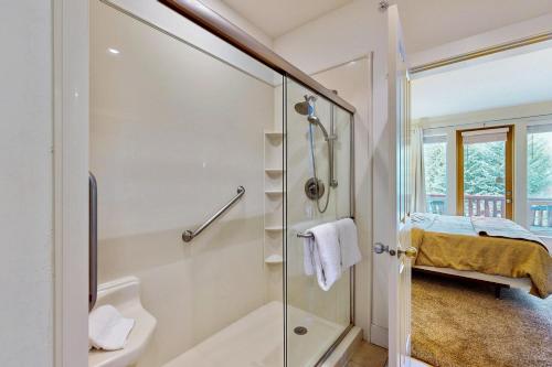 a bathroom with a shower and a glass shower stall at Wood River Condo in Ketchum