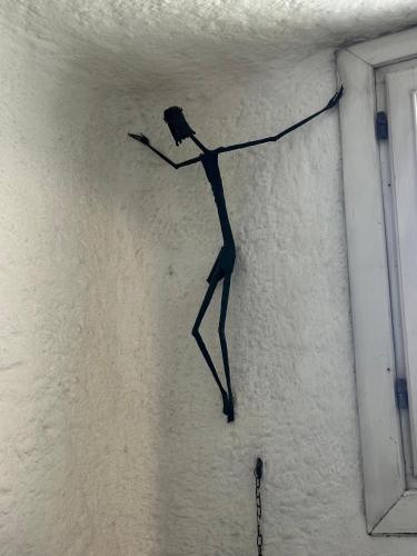 a paper person hanging on a wall at Casa Alessandra, Apartment in Porto Cervo in Porto Cervo
