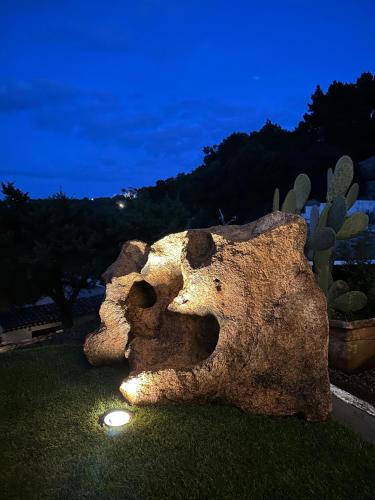 a statue of a teddy bear laying on the grass at Casa Alessandra, Apartment in Porto Cervo in Porto Cervo